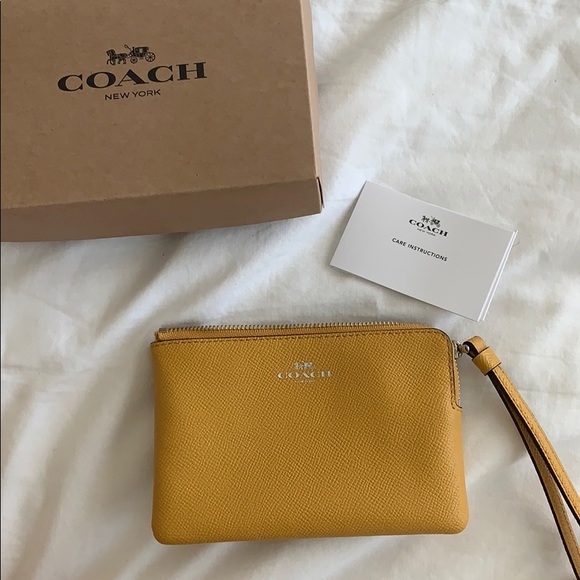 Coach Handbags - Mustard yellow coach wristlet